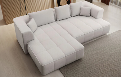 nwoczesny narożnik z luźnymi poduszkami oparciowymi i wysuwanym siedziskiem